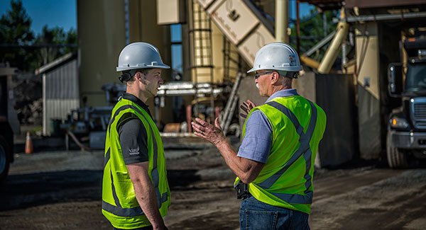 Two construction workers having a conversation.